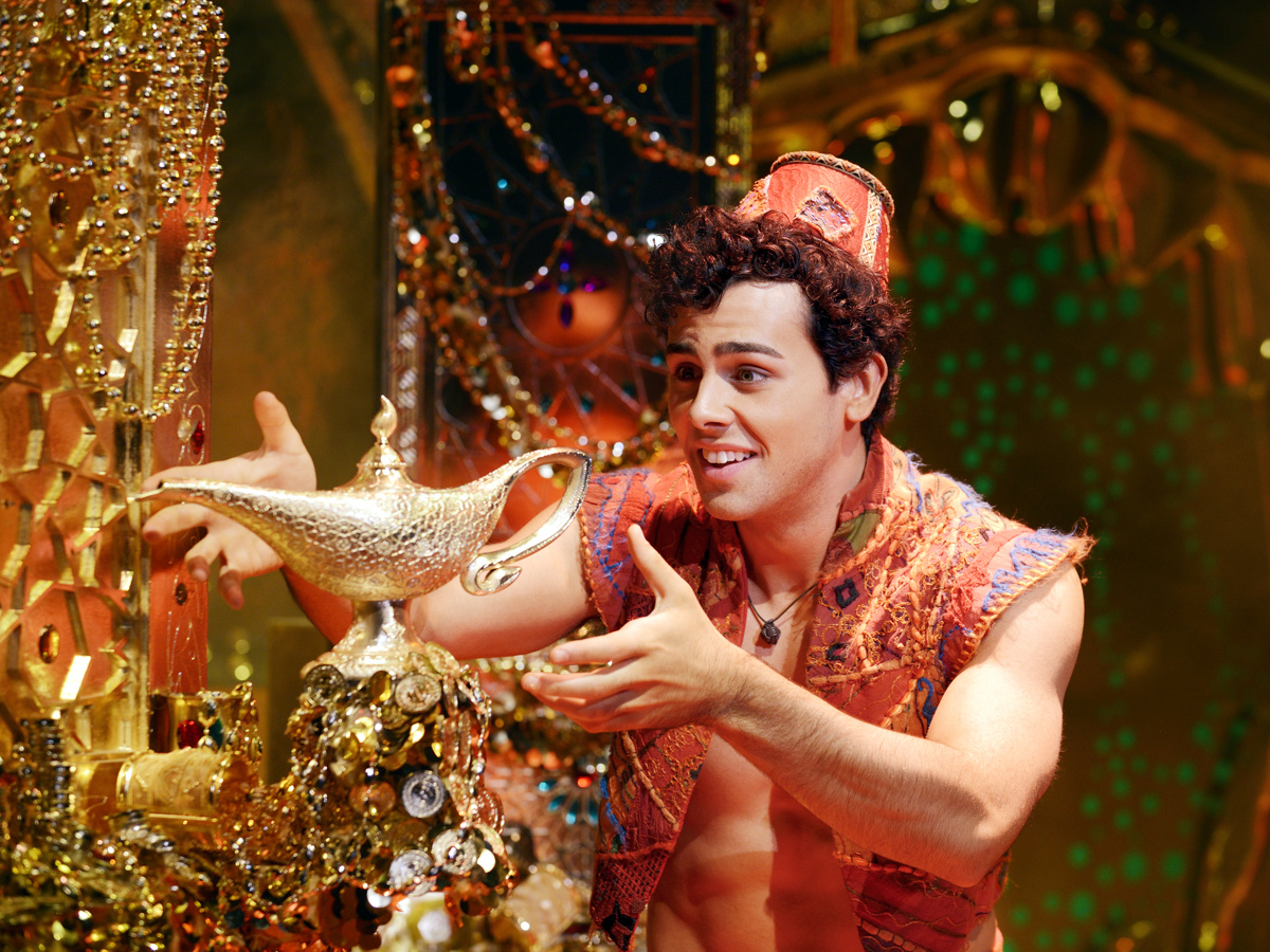 Aladdin poses with the magic lamp